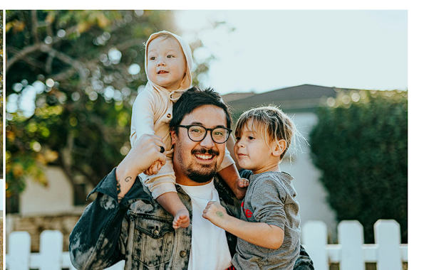 Happy family standing together outside their home, fully protected